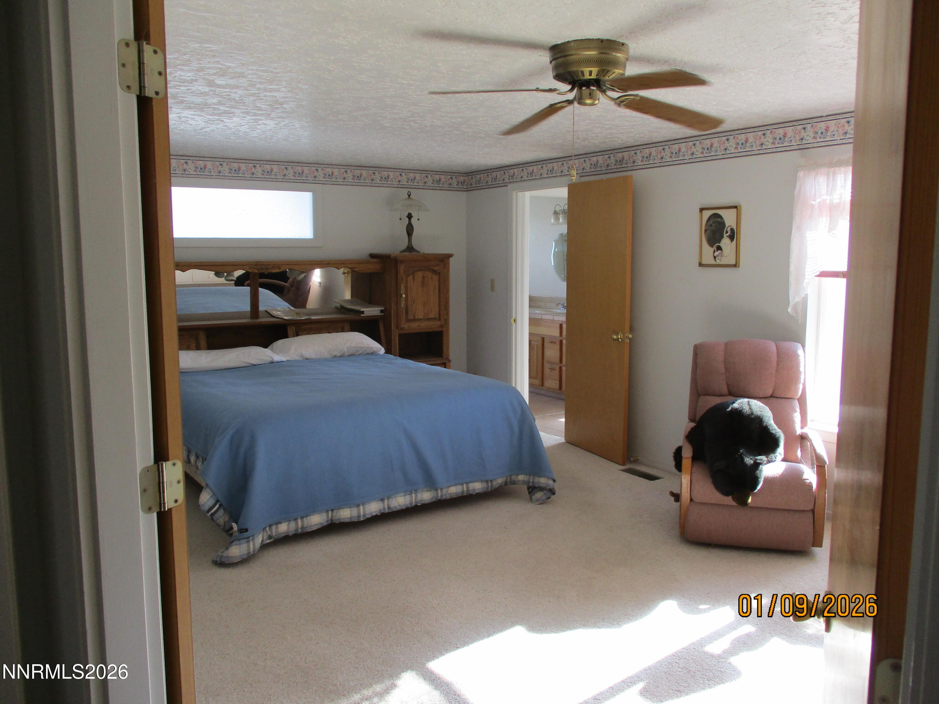 13405 Chimney Dam Road Paradise Valley, NV 89426 - Photo 30 of 90 a bedroom with a bed and a chandelier