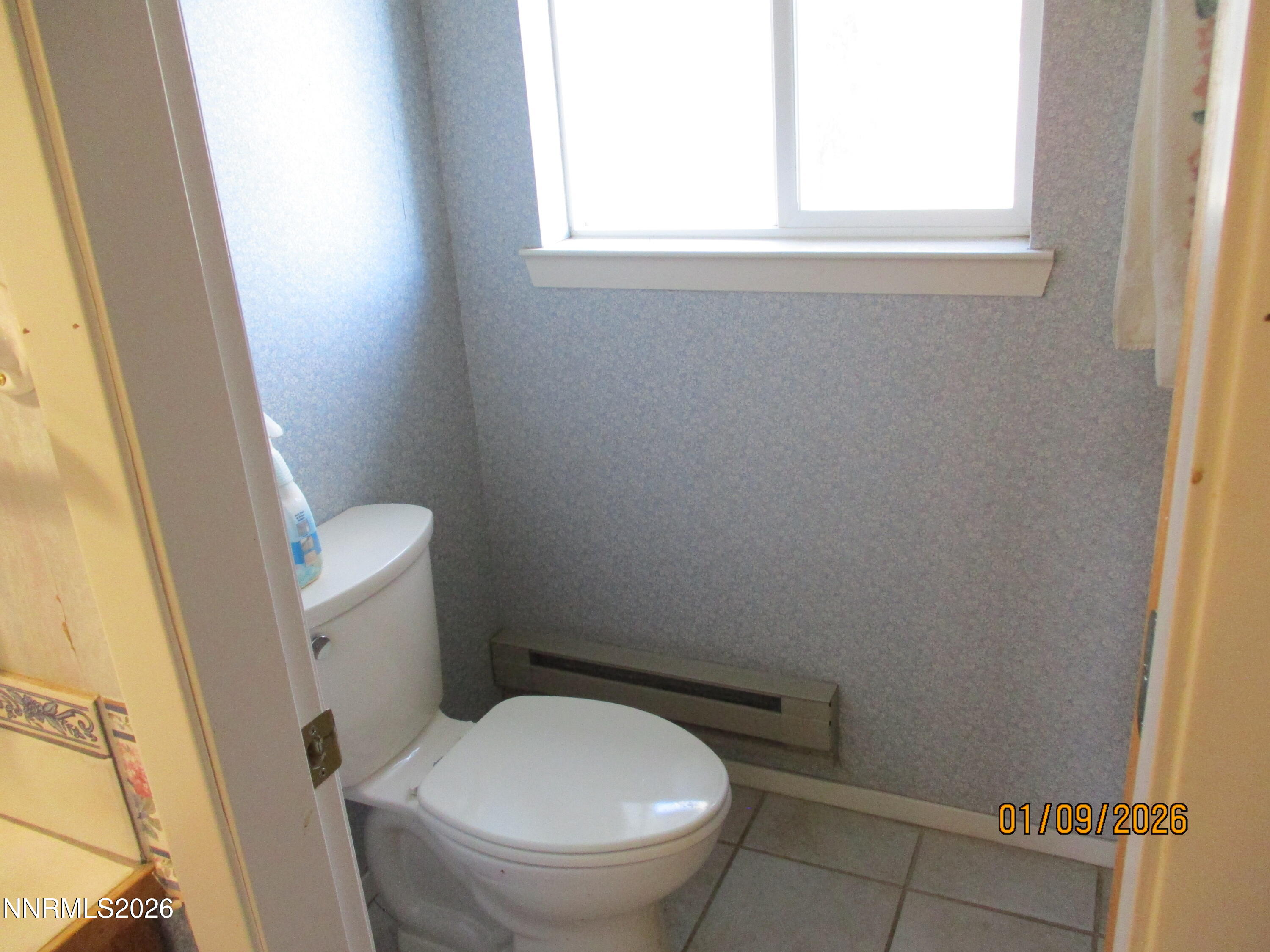 13405 Chimney Dam Road Paradise Valley, NV 89426 - Photo 34 of 90 a white toilet sitting in a bathroom next to a window