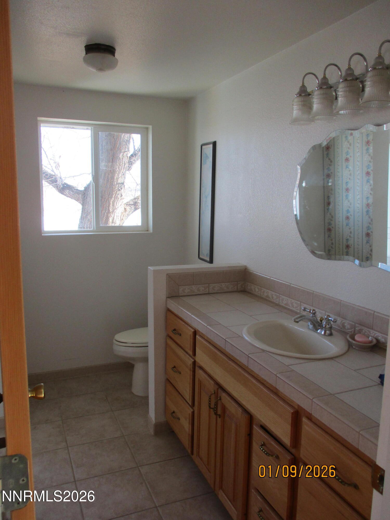 13405 Chimney Dam Road Paradise Valley, NV 89426 - Photo 38 of 90 a bathroom with a granite countertop sink and a mirror