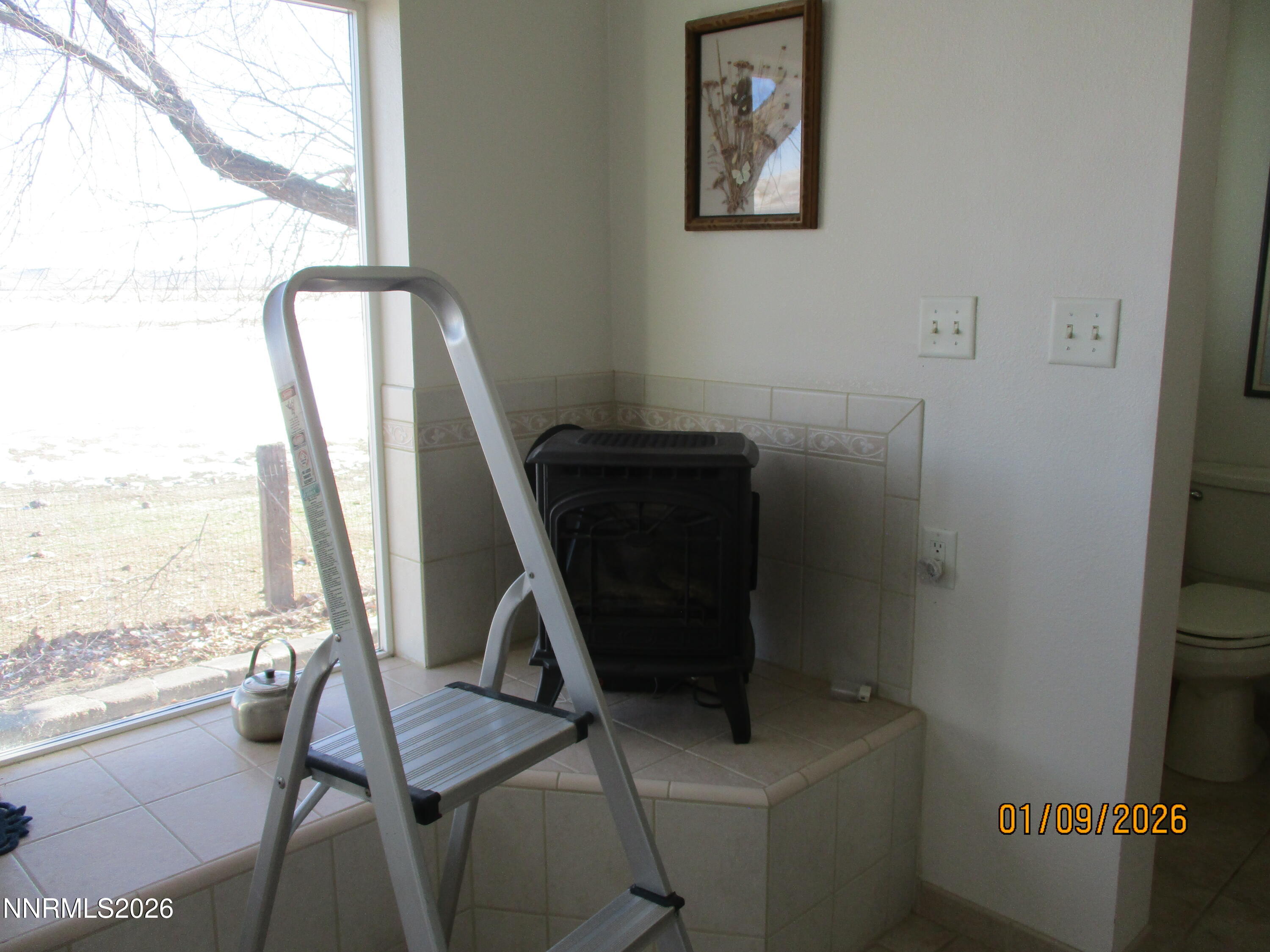 13405 Chimney Dam Road Paradise Valley, NV 89426 - Photo 42 of 90 a view of a workspace with furniture and a window