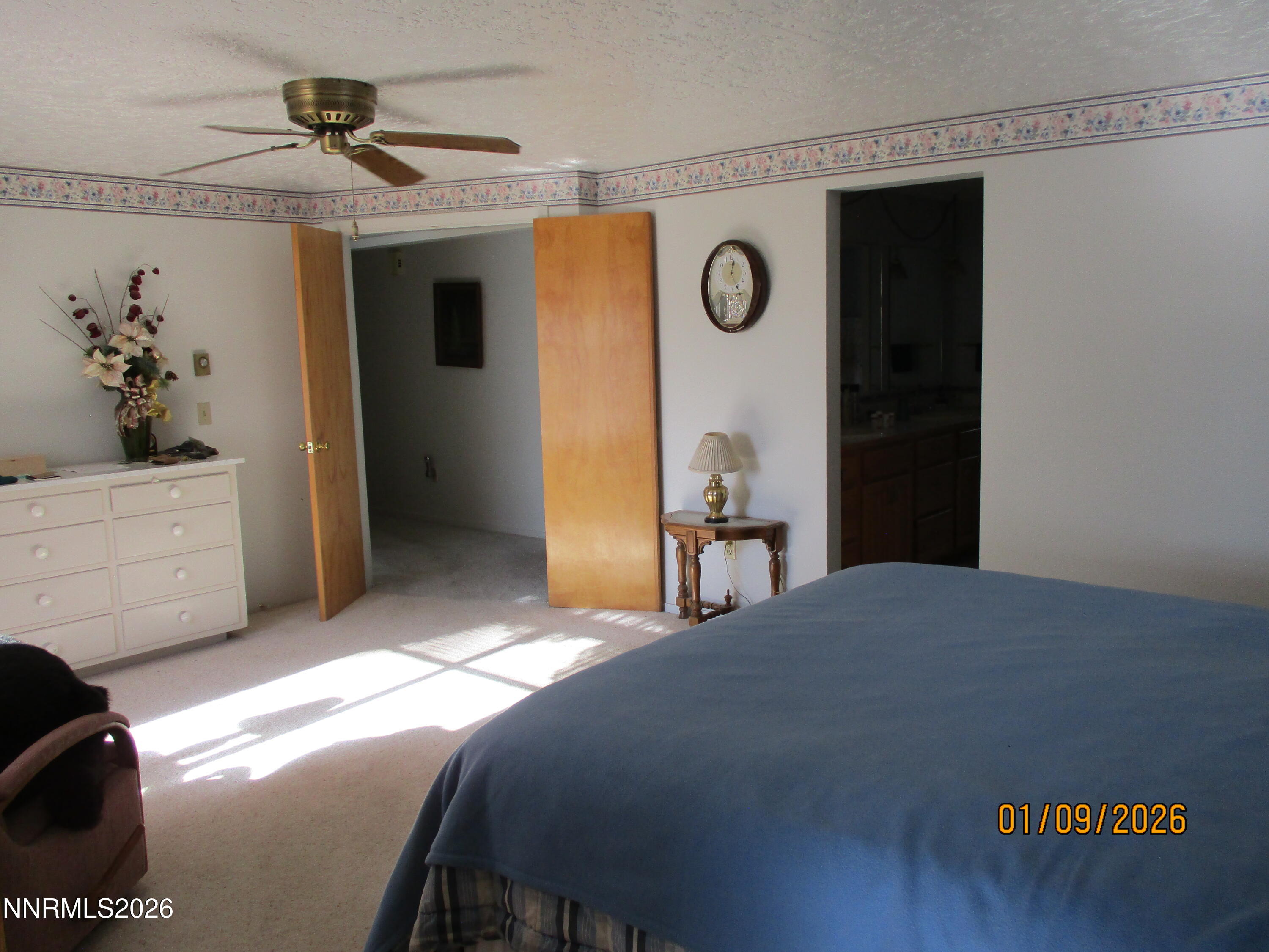 13405 Chimney Dam Road Paradise Valley, NV 89426 - Photo 46 of 90 a bedroom with a bed and a chandelier