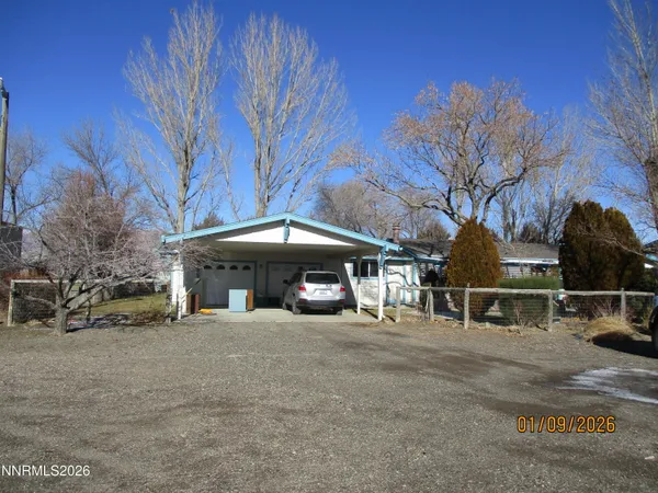 a view of a house with a yard and tree s