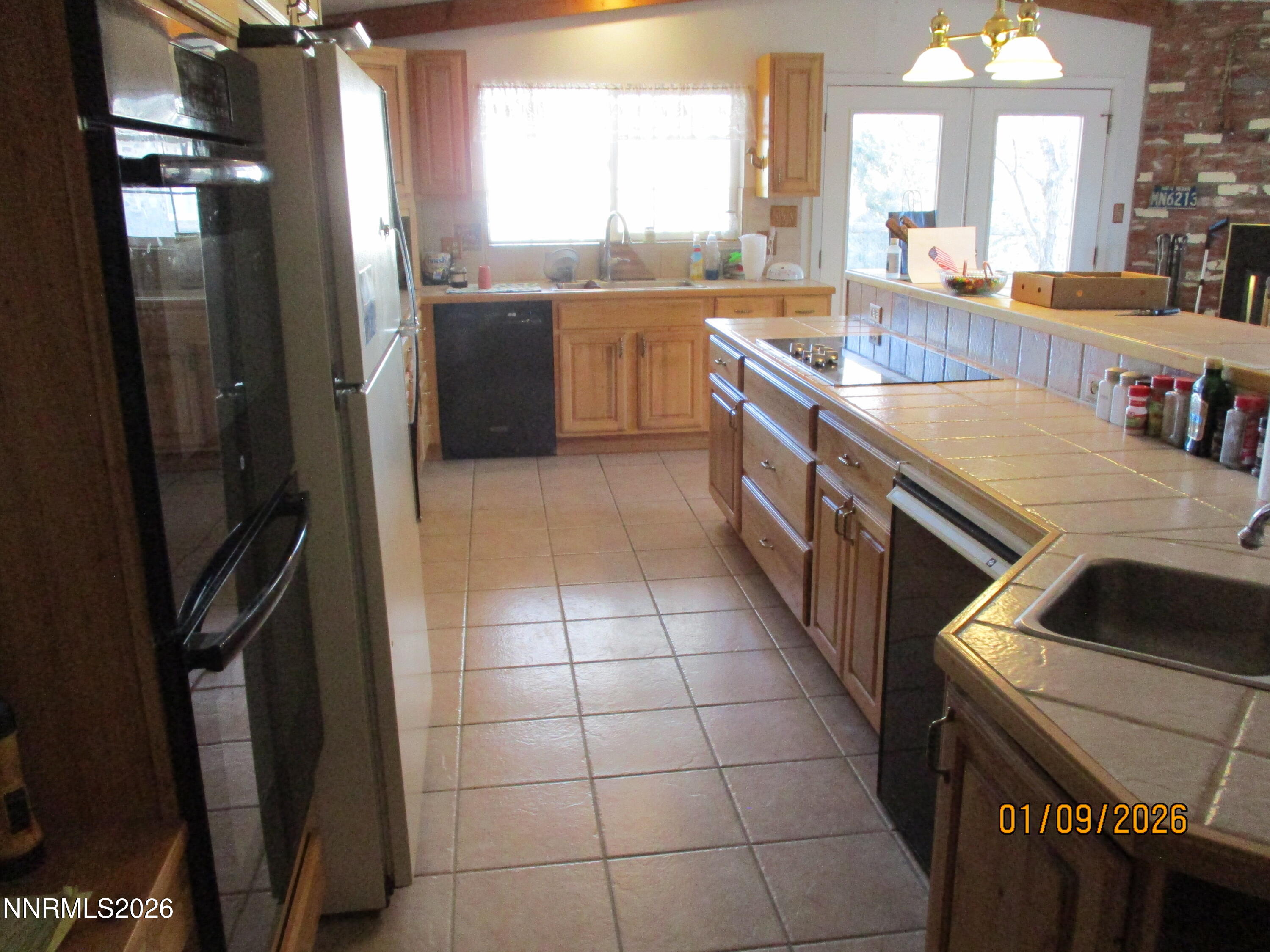13405 Chimney Dam Road Paradise Valley, NV 89426 - Photo 68 of 90 a kitchen with a sink a counter top space and stainless steel appliances