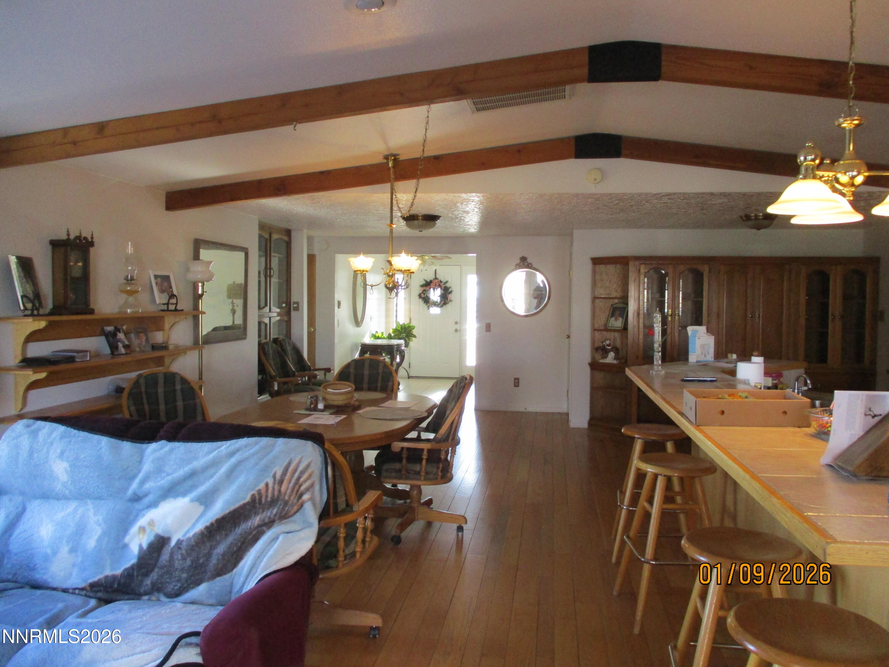 13405 Chimney Dam Road Paradise Valley, NV 89426 - Photo 75 of 90 a view of a dining room and livingroom with furniture wooden floor a chandelier