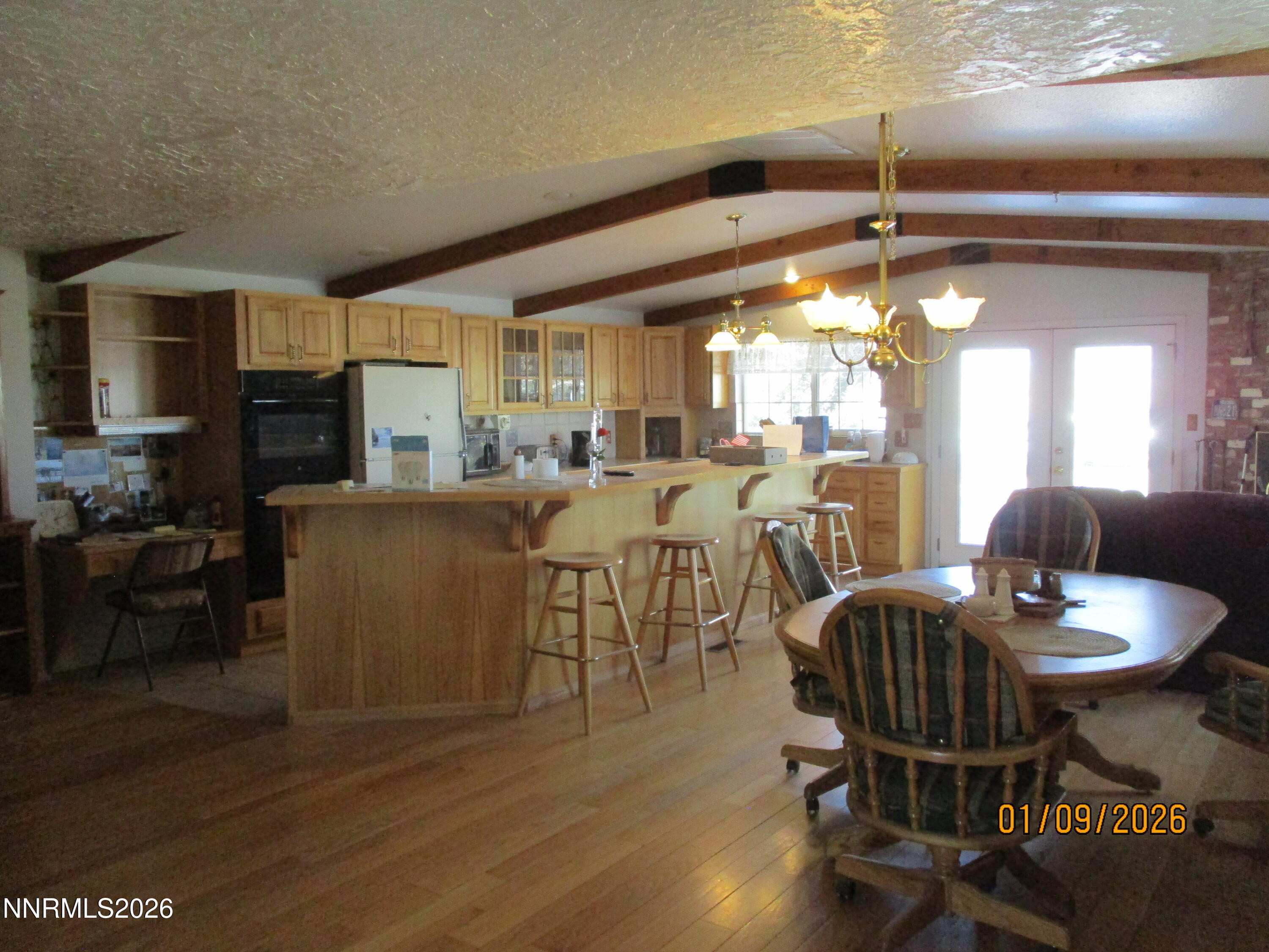 13405 Chimney Dam Road Paradise Valley, NV 89426 - Photo 79 of 90 a dining room with furniture a chandelier and wooden floor