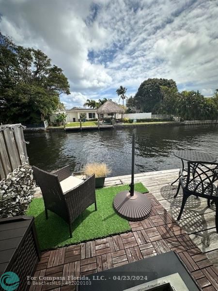 a view of a lake with couches and wooden floor