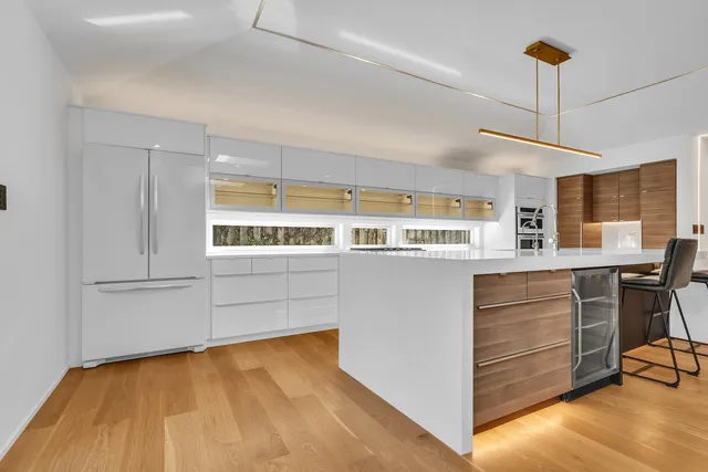 a kitchen with stainless steel appliances granite countertop a stove and a wooden floors