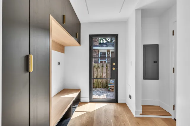 a view of a hallway with bathroom and front door