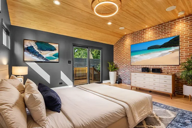 a bedroom with a bed and a flat screen tv