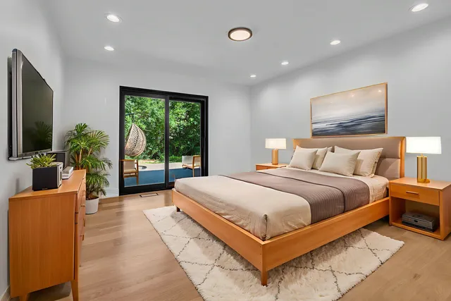 a bedroom with a large bed and a large window