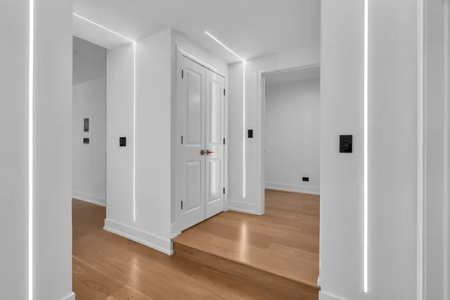 a view of a hallway with wooden floor