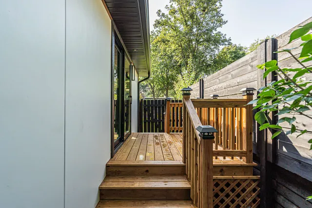 a front view of house with yard and trees in the background