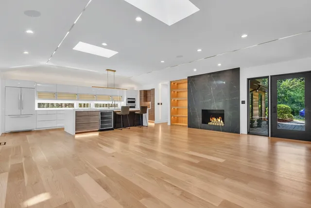a view of an empty room with a fireplace and a floor to ceiling window