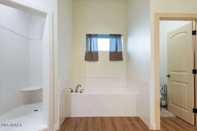 a bathroom with a bathtub and shower