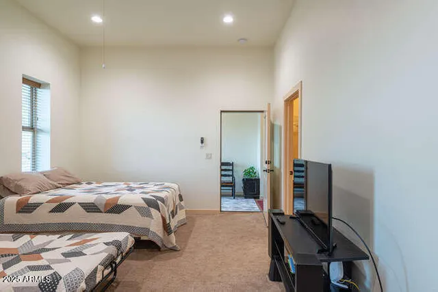 a bedroom with a bed and a desk