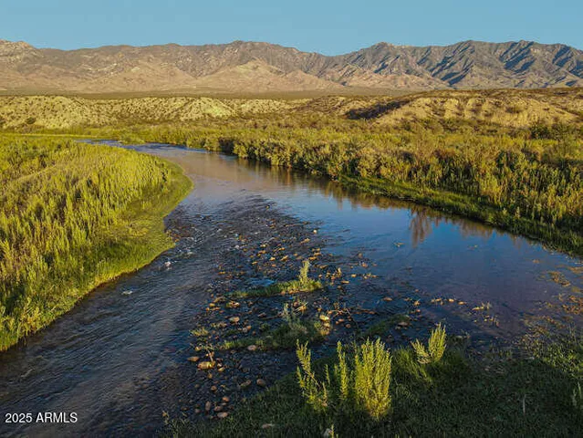 a view of an ocean with a mountain