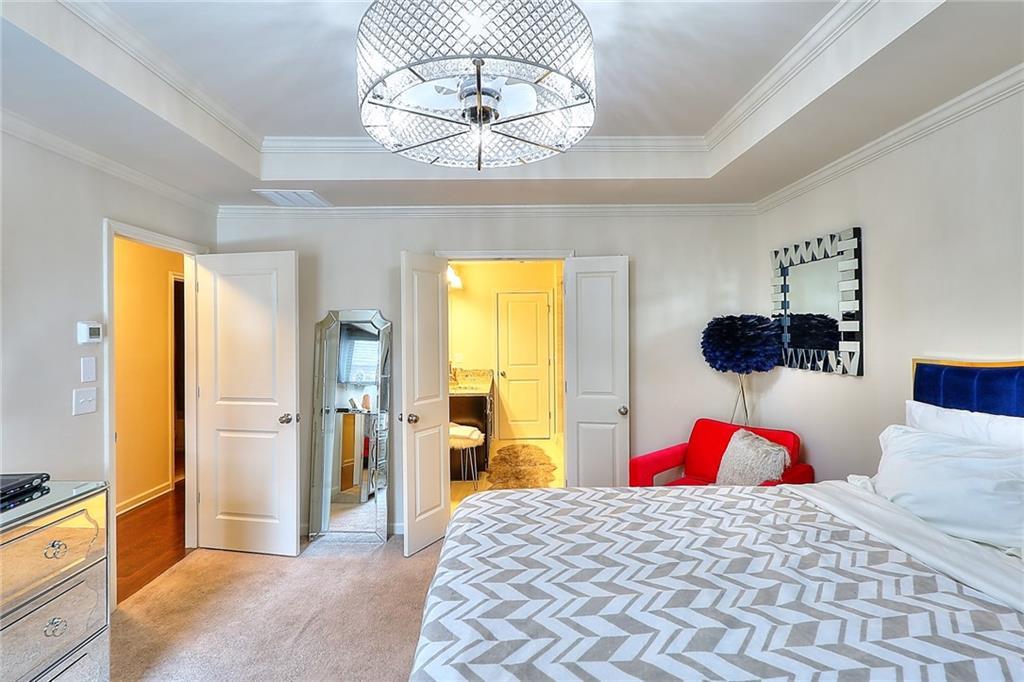 1306 Harris Way South Atlanta, GA 30319 - Photo 8 of 19 a bedroom with a bed and a chandelier