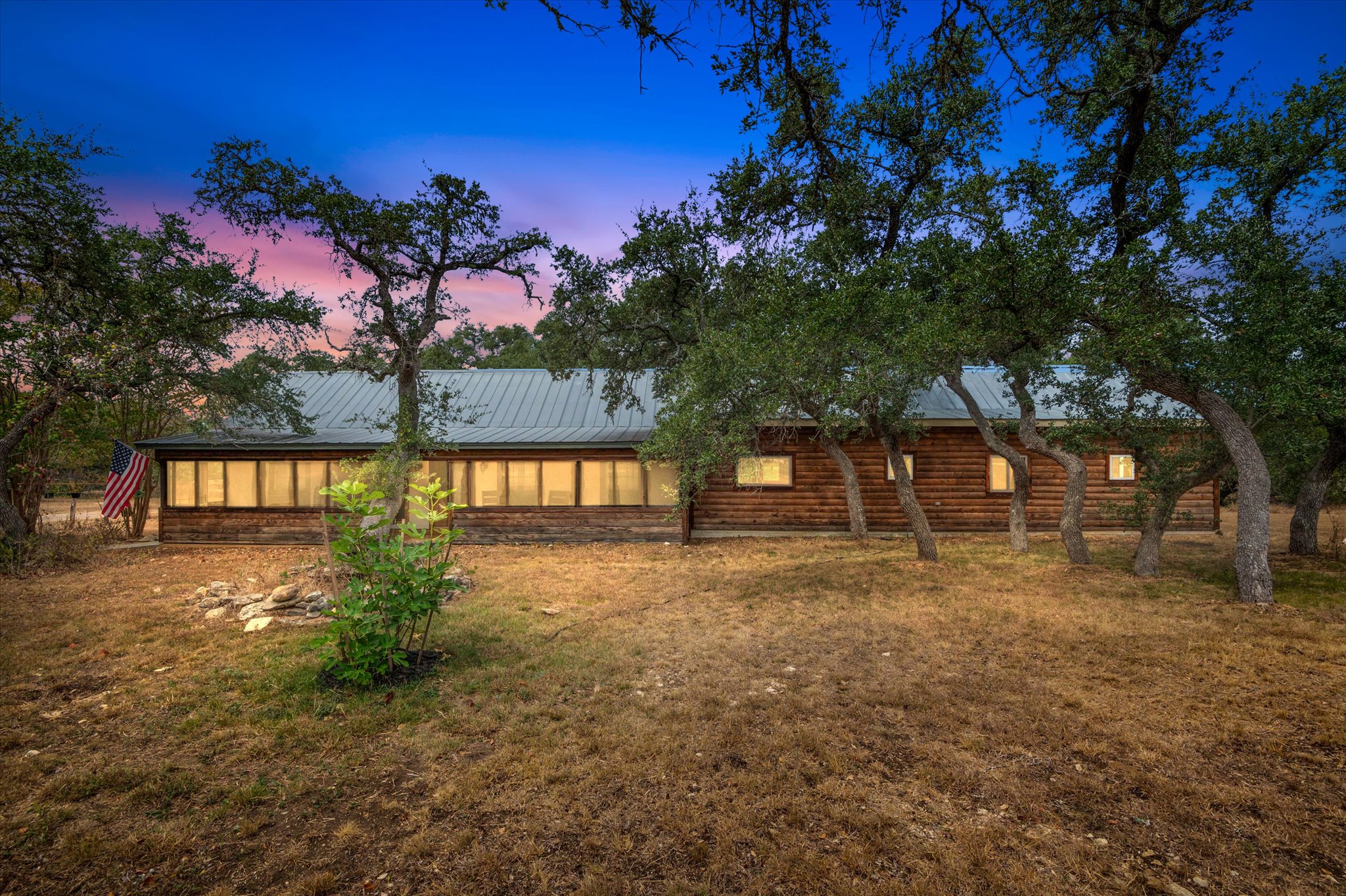 Charming Hill Country home on 4.16 acres surrounded by mature oak trees — fully gated and fenced for privacy. Relax on the screened in front porch and enjoy sunrises and sunsets and wildlife in a tranquil relaxing setting.  The address might say Go Away, but you’ll never want to leave.