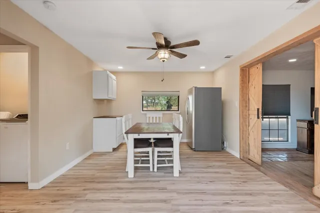 a workspace with wooden floor and windows