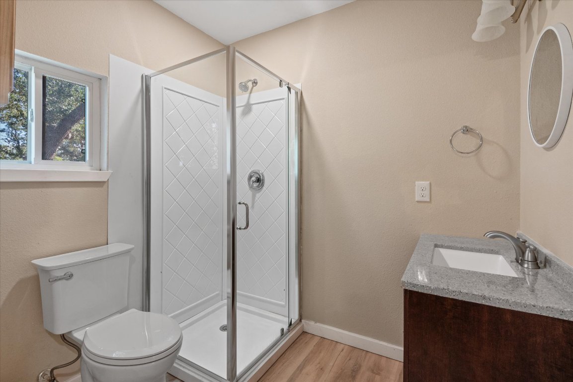 215 Go Away Road Blanco, TX 78606 - Photo 15 of 29 a bathroom with a granite countertop sink toilet and shower