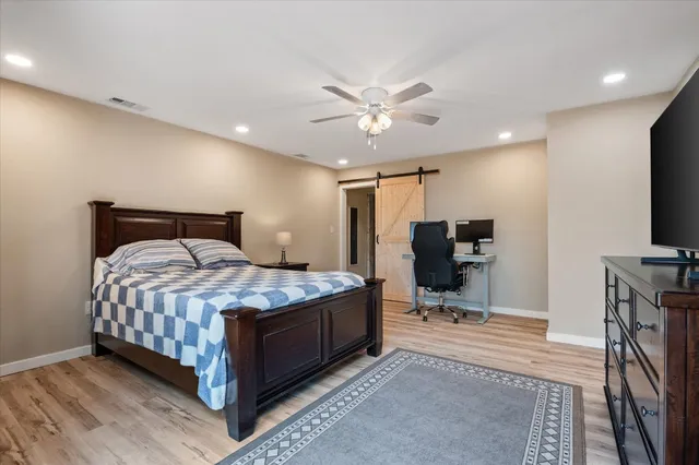 a bedroom with a bed and a flat screen tv