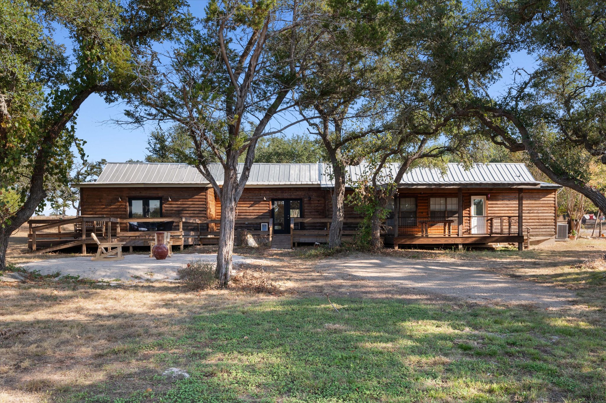 215 Go Away Road Blanco, TX 78606 - Photo 22 of 30 Backyard patio deck goes the whole length of the back of the home. Spacious back deck and outdoor seating area for relaxing, entertaining, or enjoying starry Hill Country nights. The address might say Go Away, but you’ll never want to leave.
