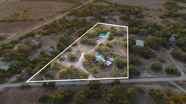 an aerial view of a house with a yard basket ball court and outdoor seating