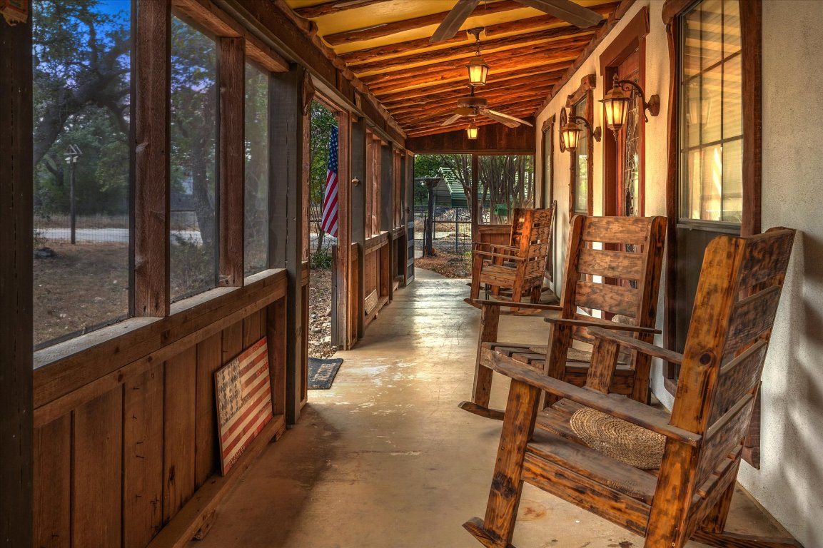215 Go Away Road Blanco, TX 78606 - Photo 3 of 29 a view of balcony with chairs and wooden fence