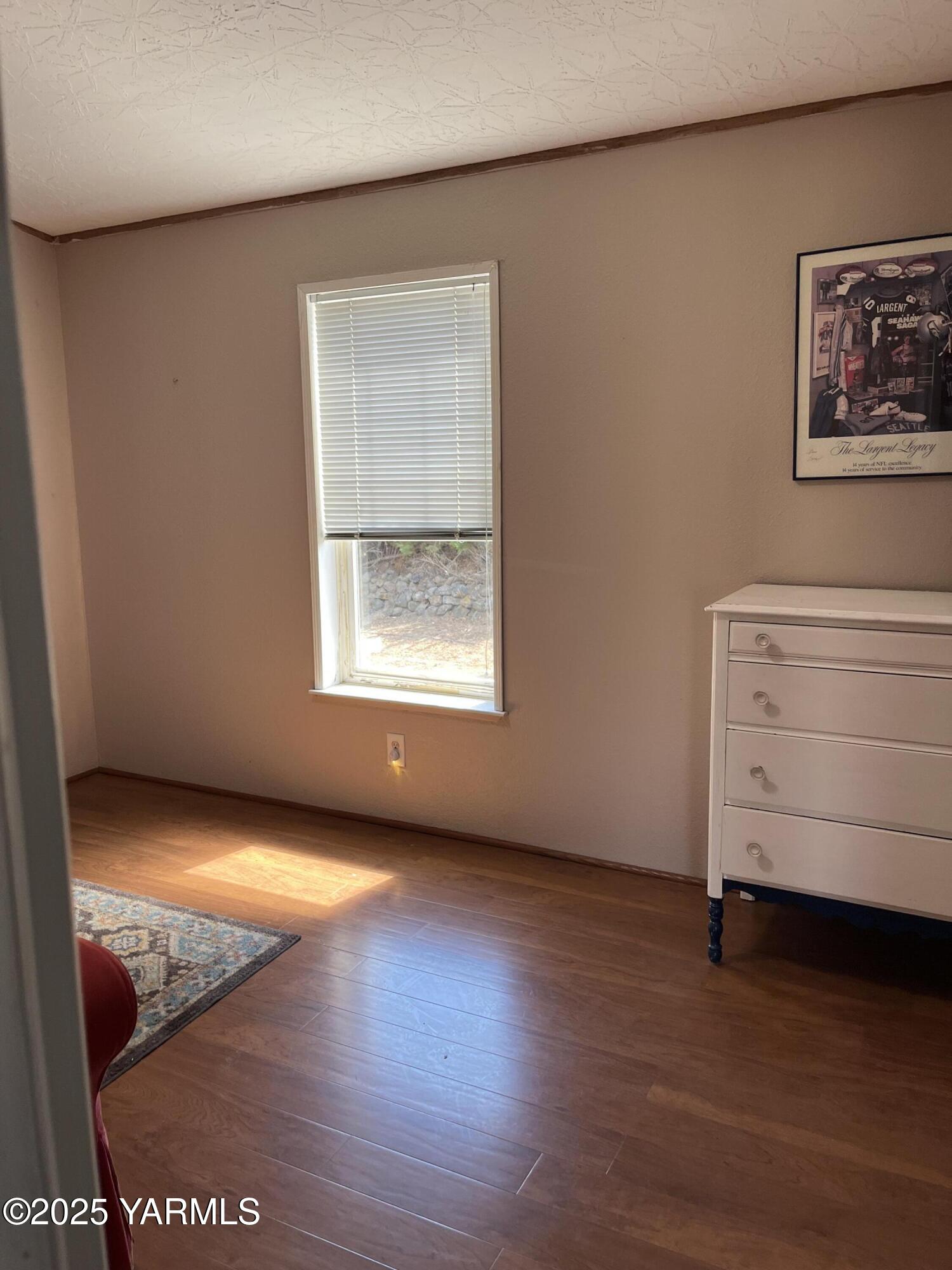 14190 North Wenas Road Selah, WA 98942 - Photo 26 of 62 a view of an empty room with a window and wooden floor
