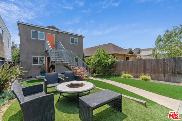 a view of an chairs and table in backyard