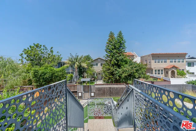 a view of a pathway of a house with a tree