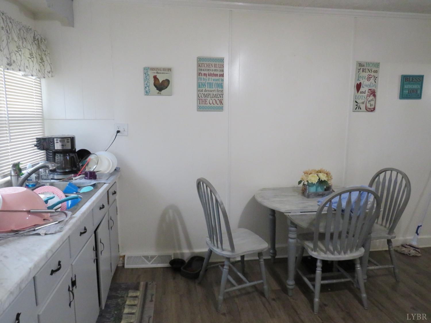 7139 Hunting Creek Road Clover, VA 24534 - Photo 10 of 19 a view of a dining room with furniture and wooden floor