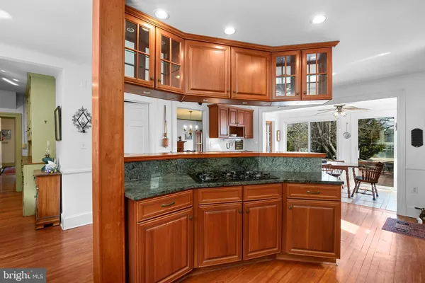 a kitchen with stainless steel appliances granite countertop a refrigerator a stove and a sink