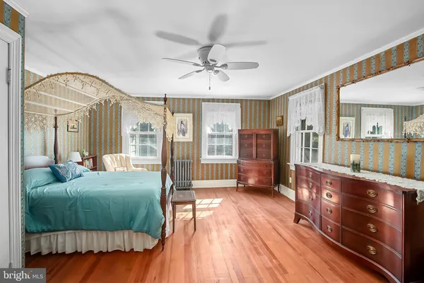 a bed sitting in a spacious bedroom next to a window