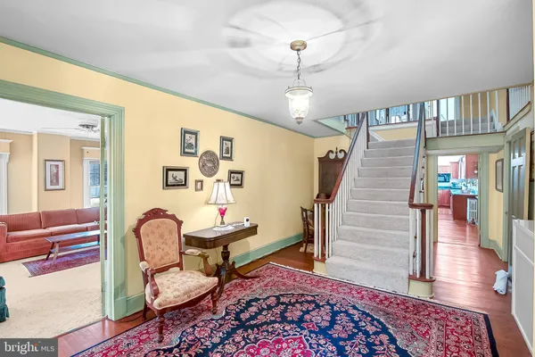 a view of entryway with wooden floor and livingroom view
