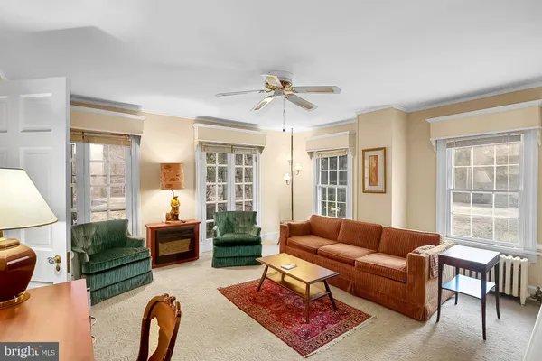 a dining room with furniture window and wooden floor