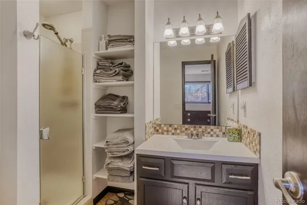 a bathroom with a sink a mirror and a shower