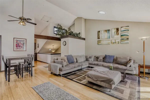 a living room with furniture and wooden floor