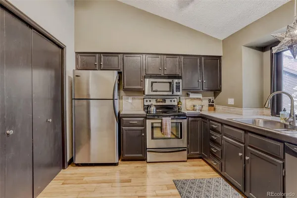 a kitchen with a refrigerator sink and microwave