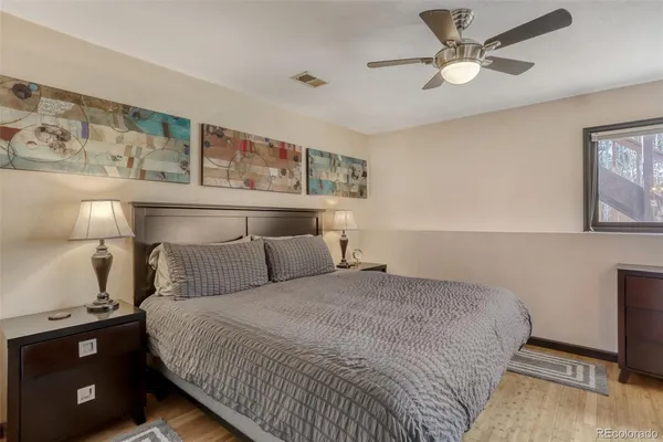 a bedroom with a bed and a night stand