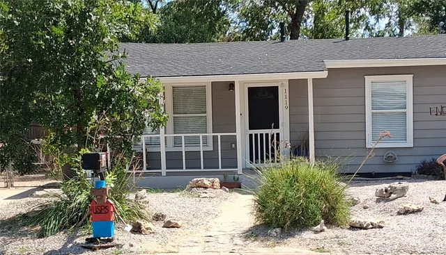 a view of a house with a yard and sitting area