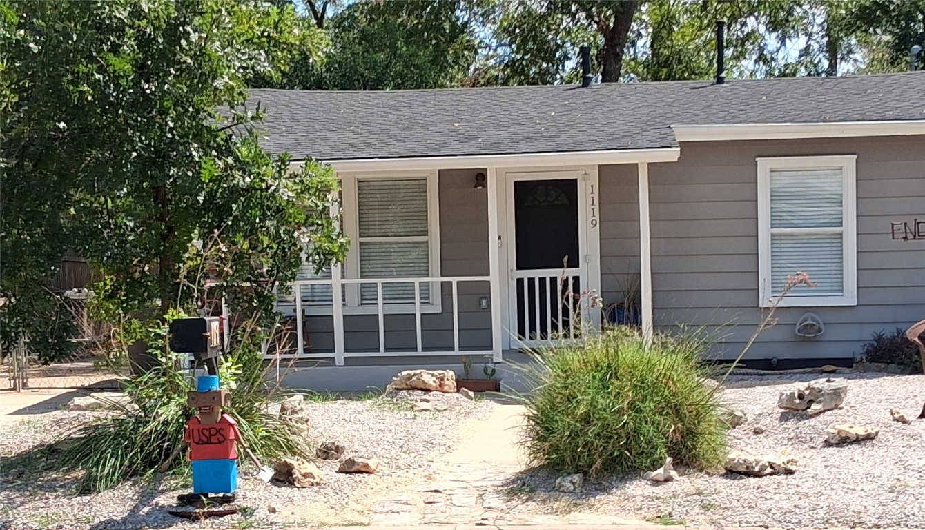 a view of a house with a yard and sitting area