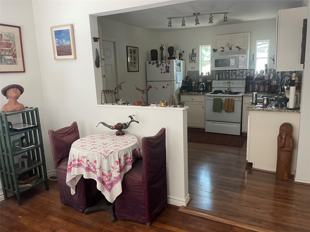 1115 Mark Street, Unit D Austin, TX 78721 - Photo 2 of 8 a bedroom with furniture and wooden floor