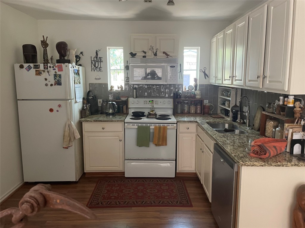 1115 Mark Street, Unit D Austin, TX 78721 - Photo 3 of 8 a kitchen with a white stove top oven and white countertops