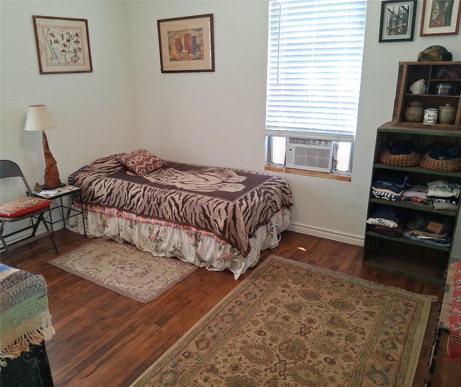 1115 Mark Street, Unit D Austin, TX 78721 - Photo 7 of 8 a bedroom with a bed and wooden floor