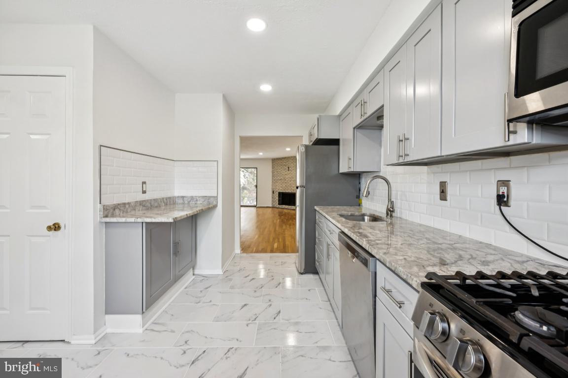 635 East Main Street, Unit 14 Moorestown, NJ 08057 - Photo 15 of 32 a kitchen with stainless steel appliances granite countertop a sink stove and refrigerator