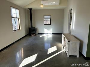 123 B Sharon Road, Unit B Millerton, NY 12546 - Photo 4 of 5 Living room with woodstove and mini split for a/c and heat