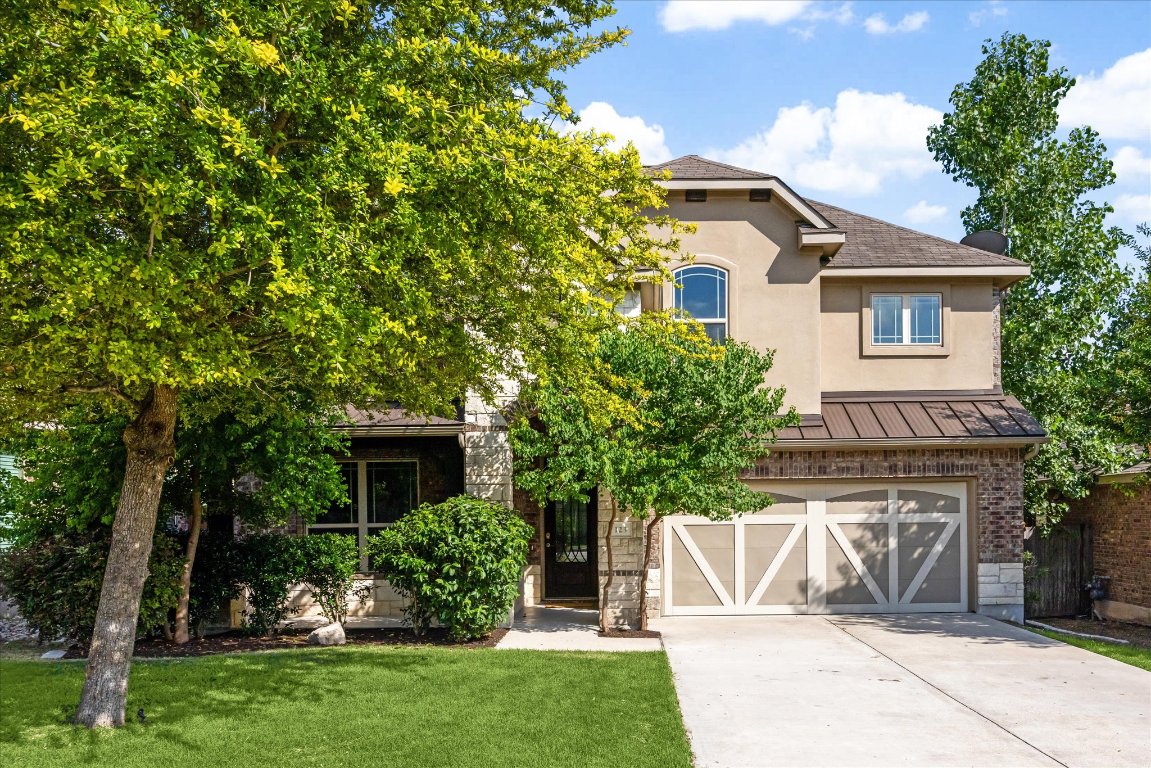 123 Pond View Pass Buda, TX 78610 - Photo 1 of 1 a view of a house with a yard and a large tree