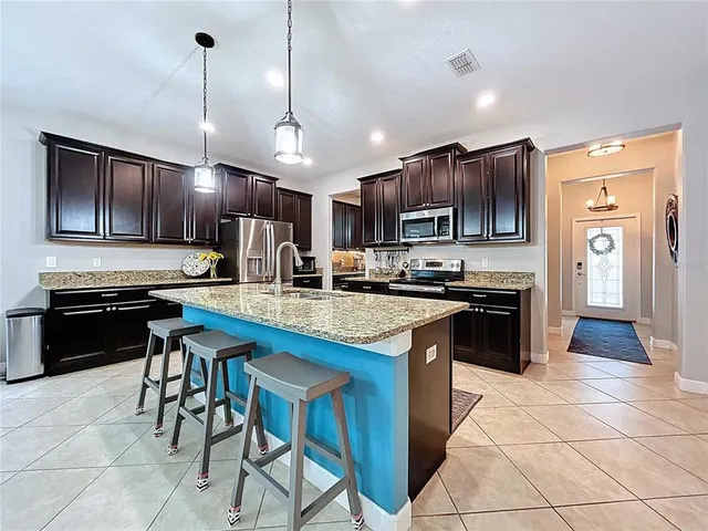 a bedroom with furniture and a chair