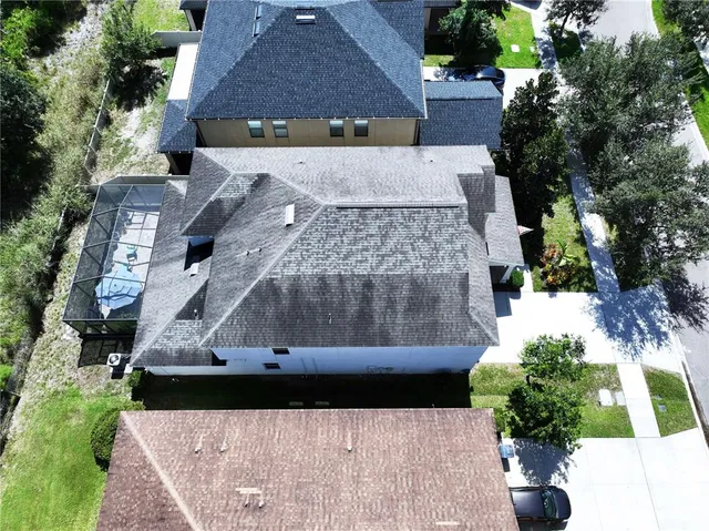 a front view of a house with a garden and trees